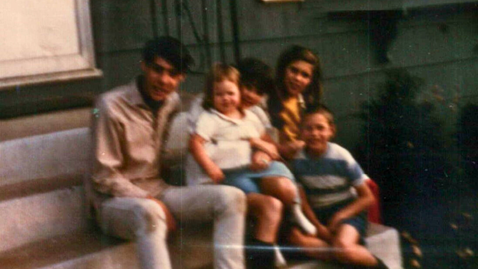 Me with my brothers and sister. It was the Spring or Summer of 1966 when I was about 15 months old. We are on the front steps of our house.
